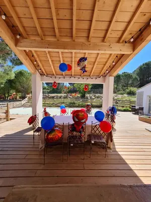 a patio with a table and chairs under a wooden ceiling at OXPIRA in Palaja