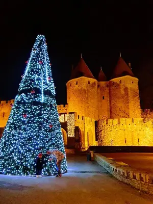 a christmas tree in front of a castle at night at OXPIRA in Palaja