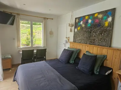 a bedroom with a bed and a painting on the wall at OXPIRA in Palaja