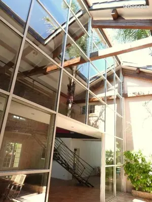 a glass facade of a building with a staircase at Chambres d'hôtes la Soulenque Luxury B & B in Capestang