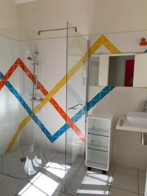 a bathroom with a glass shower and a sink at Chambres d'hôtes la Soulenque Luxury B & B in Capestang