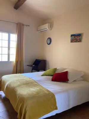 a bedroom with a bed with two pillows on it at Chambres d'hôtes la Soulenque Luxury B & B in Capestang