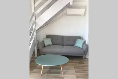 a living room with a couch and a table at Résidence Port Soleil Duplex T3 46 m2 climatisé in Gruissan
