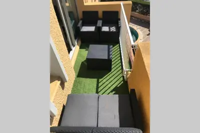 a view of a balcony with a couch and grass at Résidence Port Soleil Duplex T3 46 m2 climatisé in Gruissan