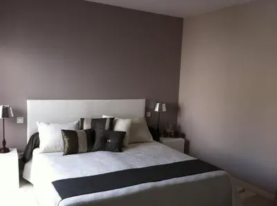 a bedroom with a large white bed with pillows at Villa Zen in Narbonne