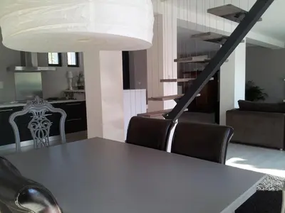 a dining room with a table and chairs at Villa Zen in Narbonne