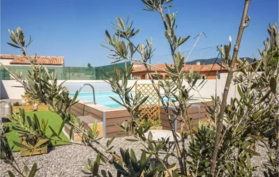 a backyard with a swimming pool and a house at 2 Bedroom Cozy Home In Saint Chinian in Saint-Chinian