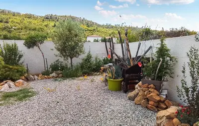 a garden with many plants and a wall at 2 Bedroom Cozy Home In Saint Chinian in Saint-Chinian
