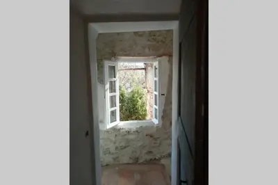 an open door with a window in a room at Character filled house overlooking the River Cesse in Bize-Minervois