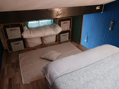 a room with a bed and some pillows at Cocoon'House in Gruissan