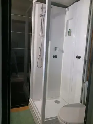 a bathroom with a shower and a toilet at Cocoon'House in Gruissan