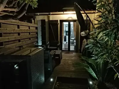 a room with a desk and a chair and some plants at Cocoon'House in Gruissan