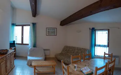 a living room with a couch and a table at Gîte Mairie in Fosse