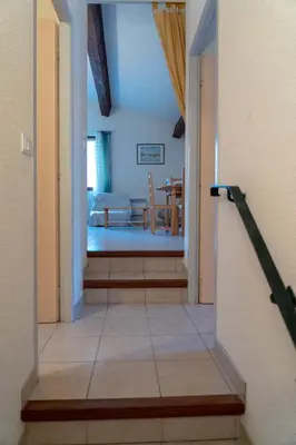 a hallway leading to a room with a dining room at Gîte Mairie in Fosse