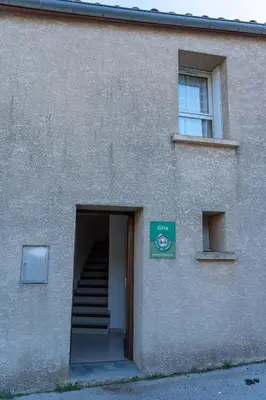 a building with a stairway leading to a door at Gîte Mairie in Fosse