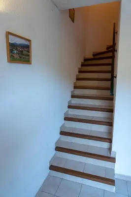 a staircase in a house with a picture on the wall at Gîte Mairie in Fosse