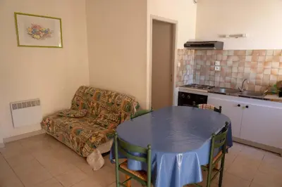 a living room with a table and a couch at Gîte La Place in Fosse