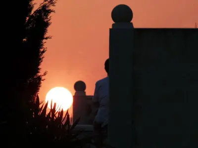 a man and a child looking at the sunset at Château De Massignan in Saint-Marcel