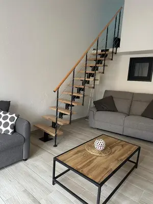 a living room with a couch and a table at New Maison tout confort, bord de mer avec Parking Privé in Gruissan