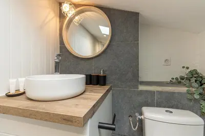a bathroom with a white sink and a mirror at Le Boheme - Netflix - Wifi - Vue sur la Cité Médiévale et les toits in Carcassonne