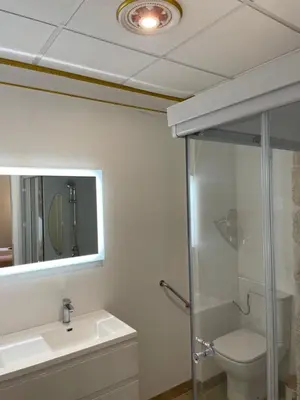 a bathroom with a toilet and a sink and a mirror at Chambre Lyre Maison de L'Église du Couvent in Narbonne