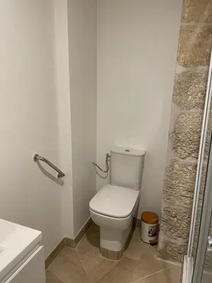 a white bathroom with a toilet and a sink at Chambre Lyre Maison de L'Église du Couvent in Narbonne