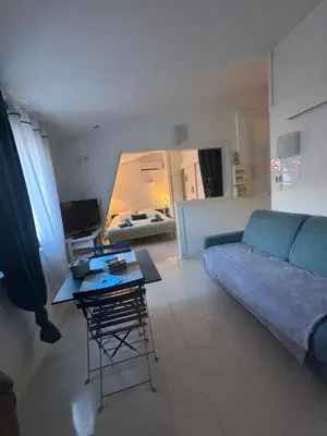 a living room with a couch and a table at LE CORS’HALLES in Narbonne