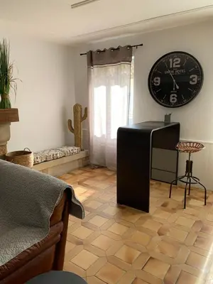 a living room with a couch and a table at Appartement la corde a linge Gruissan village avec terrasses in Gruissan