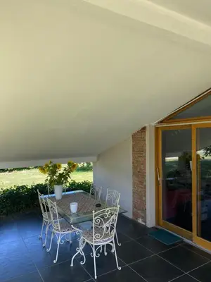a patio with a table and chairs on a porch at Location gîte 4 personnes Mazères - La Petite Maison in Mazères