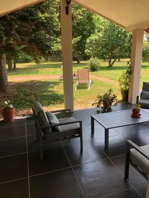a porch with a couch and a coffee table at Location gîte 4 personnes Mazères - La Petite Maison in Mazères