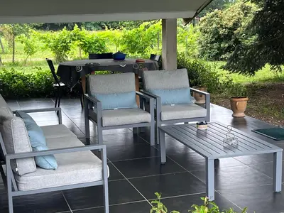 two chairs and a table on a patio at Location gîte 4 personnes Mazères - La Petite Maison in Mazères