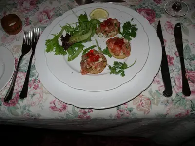 a plate of food on a table with fork and knife at L'Impasse du Temple in Léran
