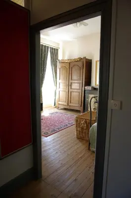 an open door to a room with a bedroom at L'Impasse du Temple in Léran