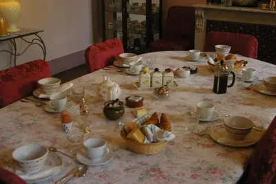 a dining room table with a table cloth with food on it at L'Impasse du Temple in Léran