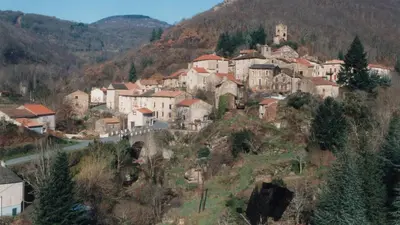 a small town on a hill with houses on it at Gîte Roc Suzadou in Ferrals-les-Montagnes