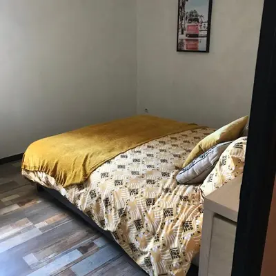 a bedroom with a bed with a comforter and pillows at MARINA 2 in Narbonne