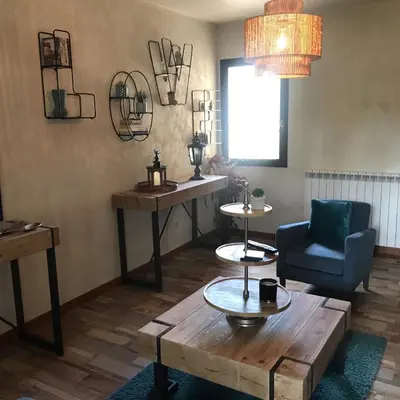 a living room with a wooden table and a chair at MARINA 2 in Narbonne