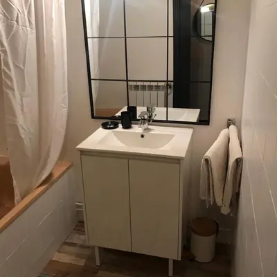 a bathroom with a sink and a mirror and a tub at MARINA 2 in Narbonne