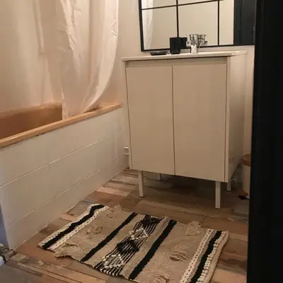 a bathroom with a sink and a mirror and a rug at MARINA 2 in Narbonne