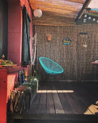 a blue bench sitting on a wooden deck at Gîte Tanagra : Maison avec piscine et vue exceptionnelle in Roquefort-les-Cascades