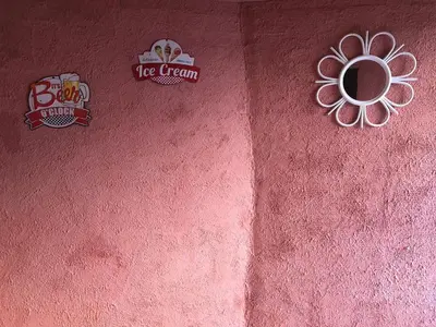 a pink wall with three stickers on it at Gîte Tanagra : Maison avec piscine et vue exceptionnelle in Roquefort-les-Cascades