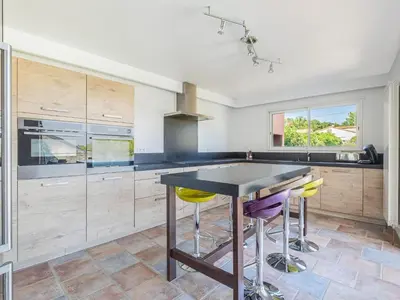 a kitchen with a table and some yellow bar stools at Retreat in Saint Denis in Saint-Denis