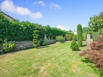 a garden with a stone wall and a yard at Retreat in Saint Denis in Saint-Denis