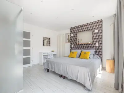 a bedroom with a large bed with yellow pillows at Retreat in Saint Denis in Saint-Denis