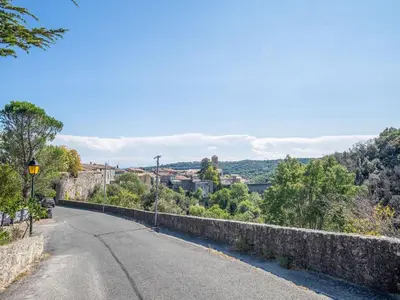 an empty road next to a stone wall at Retreat in Saint Denis in Saint-Denis
