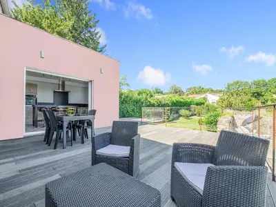 a patio with a table and chairs and a kitchen at Retreat in Saint Denis in Saint-Denis