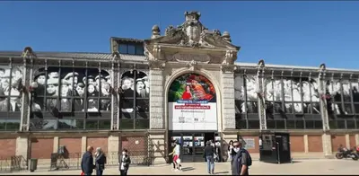 a large building with people walking in front of it at Le studio des halles avec climatisation 15m2 in Narbonne