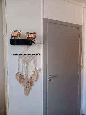 a white refrigerator next to a door with teddy bears at Le studio des halles avec climatisation 15m2 in Narbonne