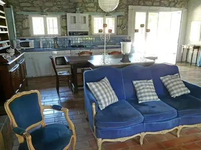 a blue couch and two chairs in a kitchen at Villa L'ESTRADE in Montréal