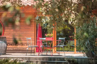a table and chairs sitting on a patio at Chambre d’Hôtes Neptune Wood in Arzens